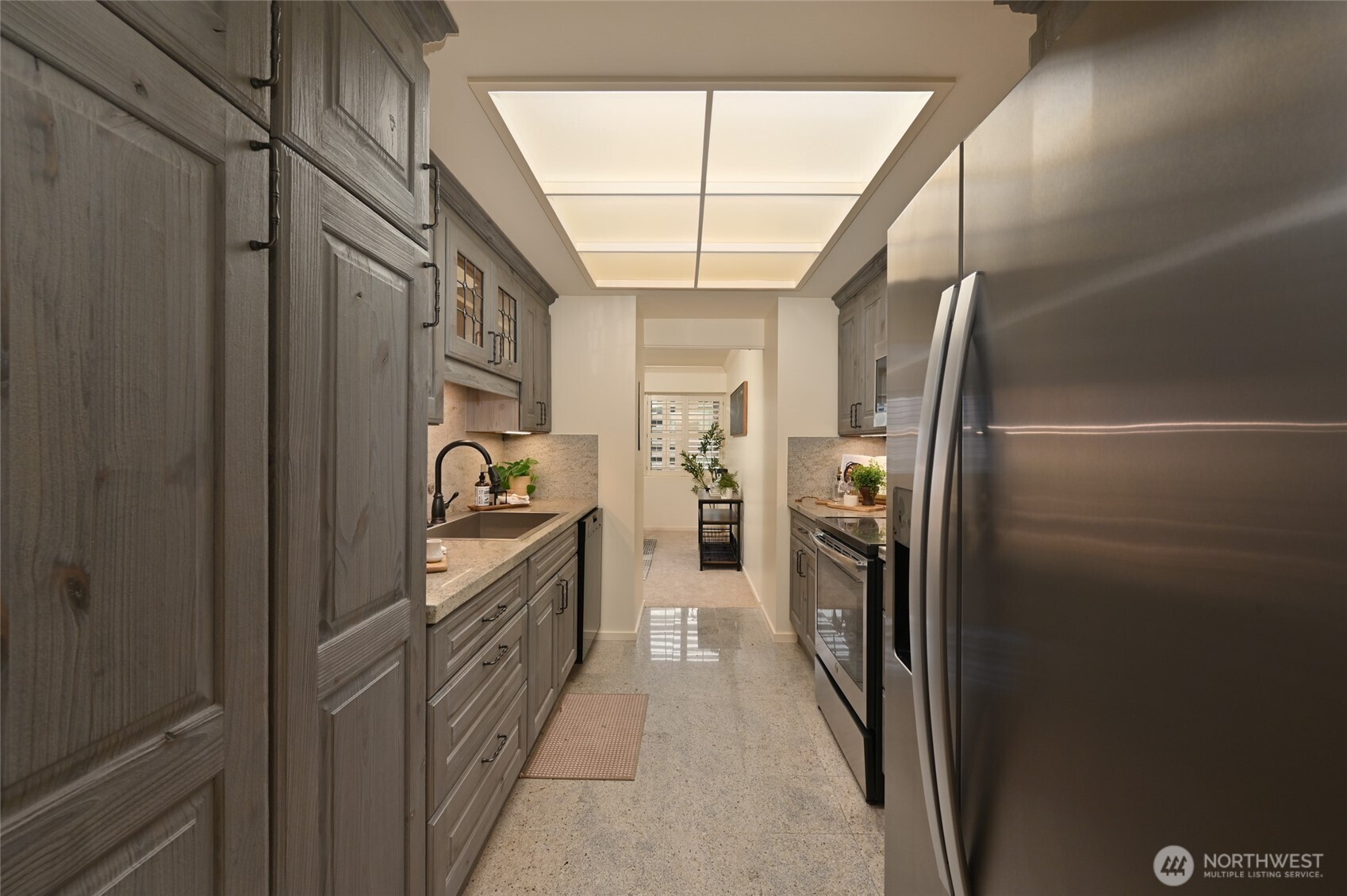 1301 Spring Street, Unit 6D Seattle, WA 98104 - Photo 9 of 29 a kitchen with a refrigerator and a stove