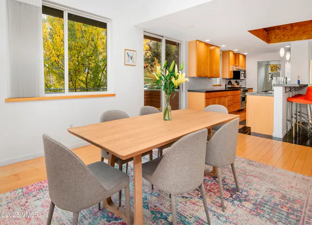 a dining room with furniture a window and appliances