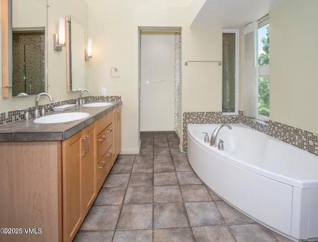 a bathroom with a bathtub and a sink