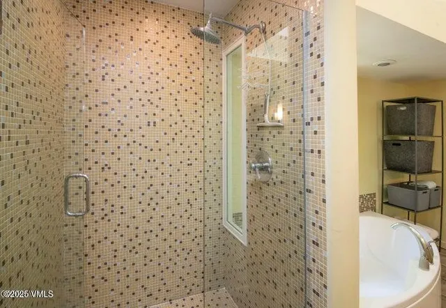 a bathroom with a shower and a sink
