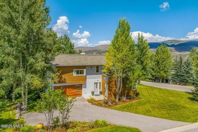 a view of a house with fountain bath and trees around