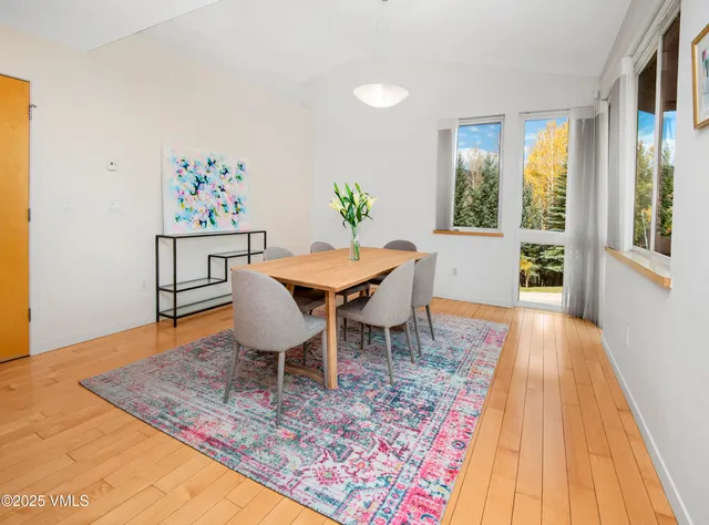 a view of a dining room with furniture window and wooden floor