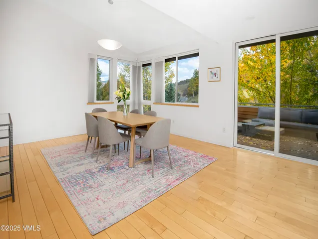 a dining room with furniture and wooden floor