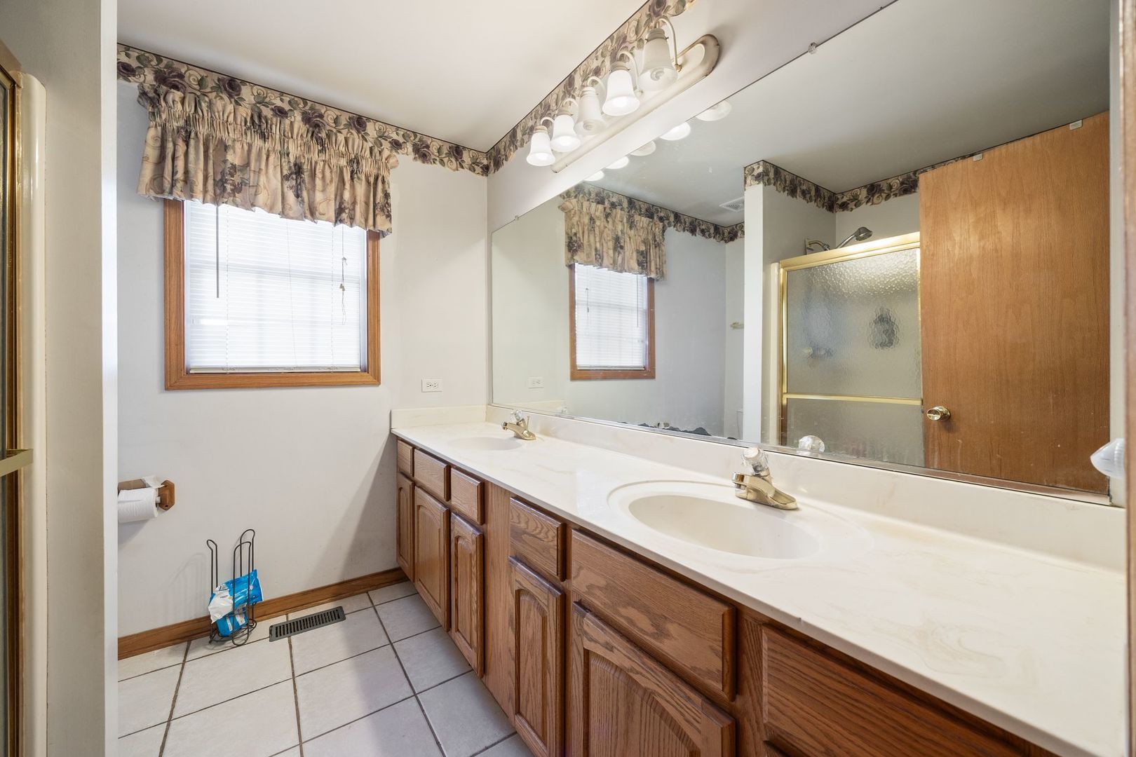 3207 Sandy Ridge Drive Steger, IL 60475 - Photo 11 of 20 a bathroom with a double vanity sink and a mirror