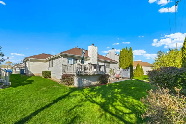 a front view of a house with a garden and yard
