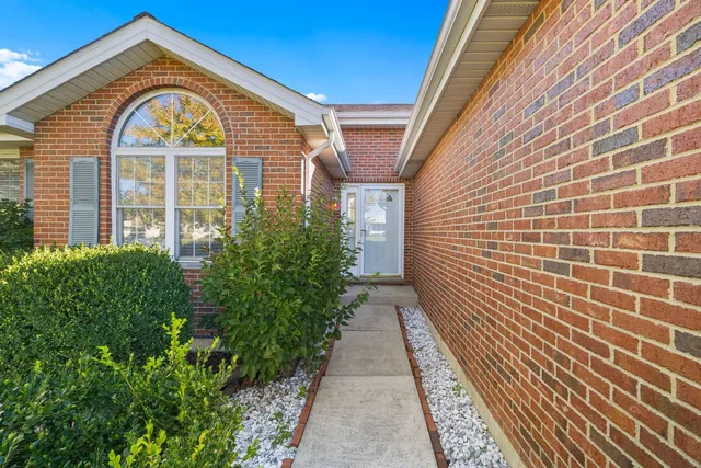a view of a brick house with many windows