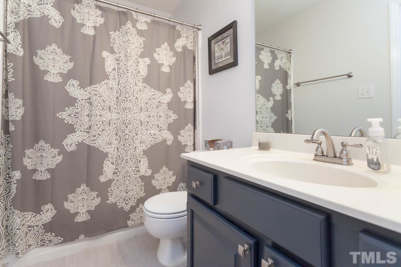 6708 Twin Tree Court Raleigh, NC 27613 - Photo 14 of 25 a bathroom with a sink toilet and shower