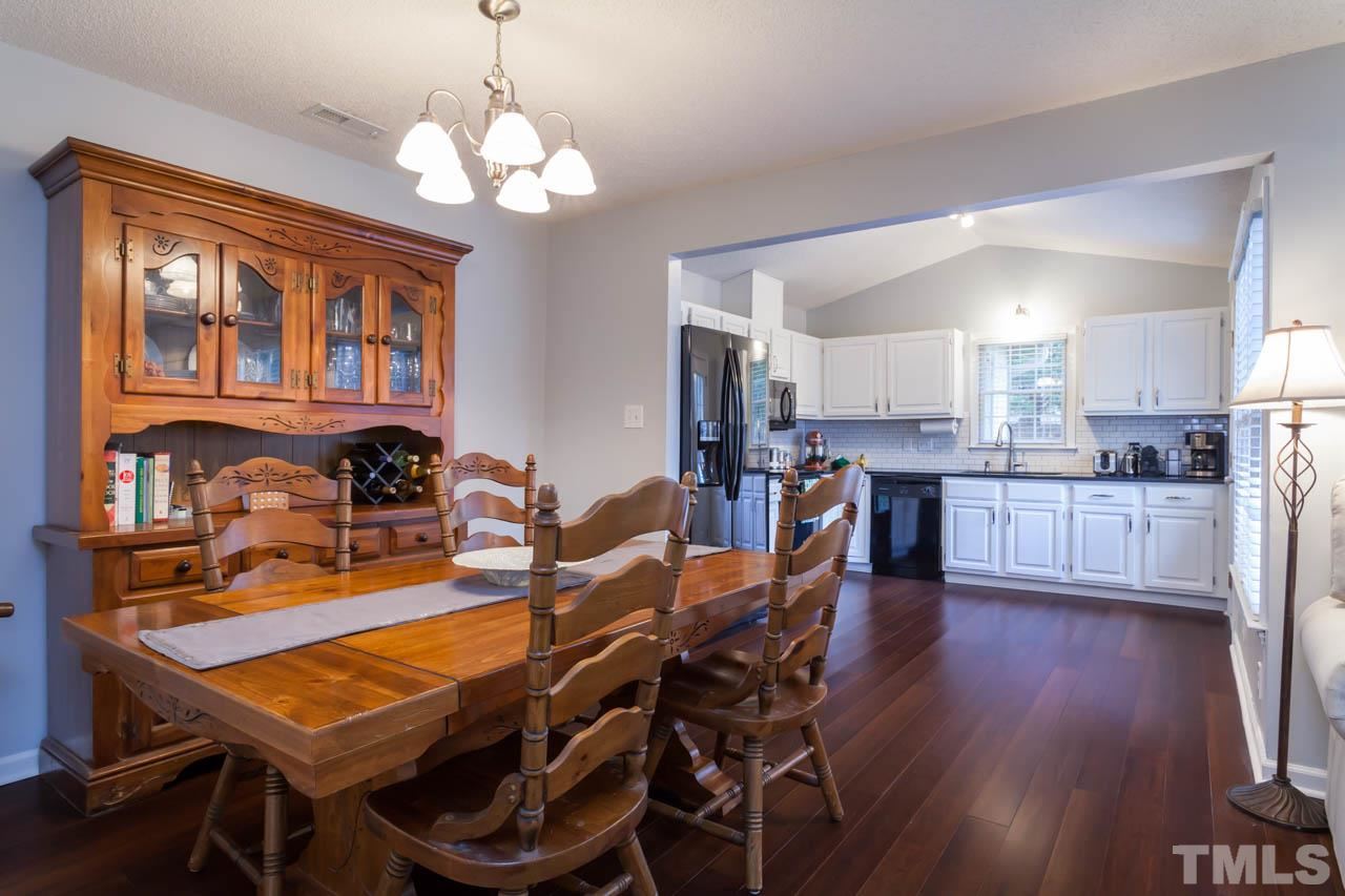 6708 Twin Tree Court Raleigh, NC 27613 - Photo 8 of 25 a view of a dining room with furniture and wooden floor