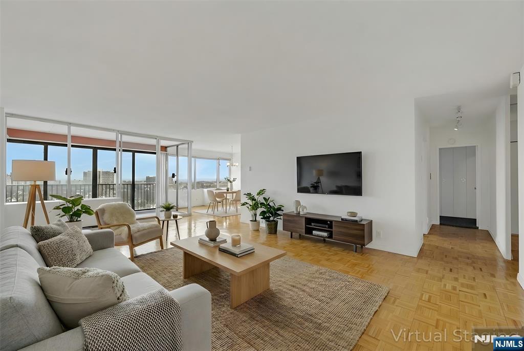 a living room with furniture and a flat screen tv