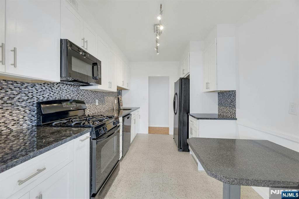 6 Horizon Road, Unit 1508 Fort Lee, NJ 07024 - Photo 18 of 46 a kitchen with stainless steel appliances granite countertop a stove top oven a sink a refrigerator and a granite counter tops