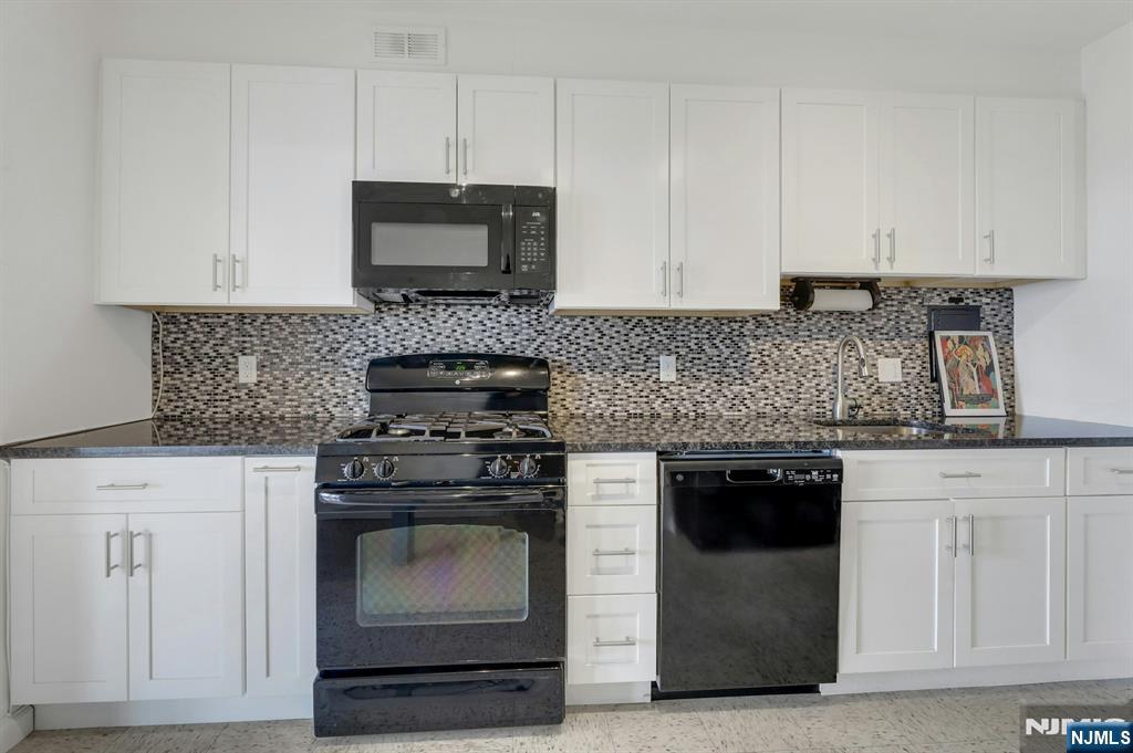 6 Horizon Road, Unit 1508 Fort Lee, NJ 07024 - Photo 21 of 46 a kitchen with granite countertop white cabinets and stainless steel appliances