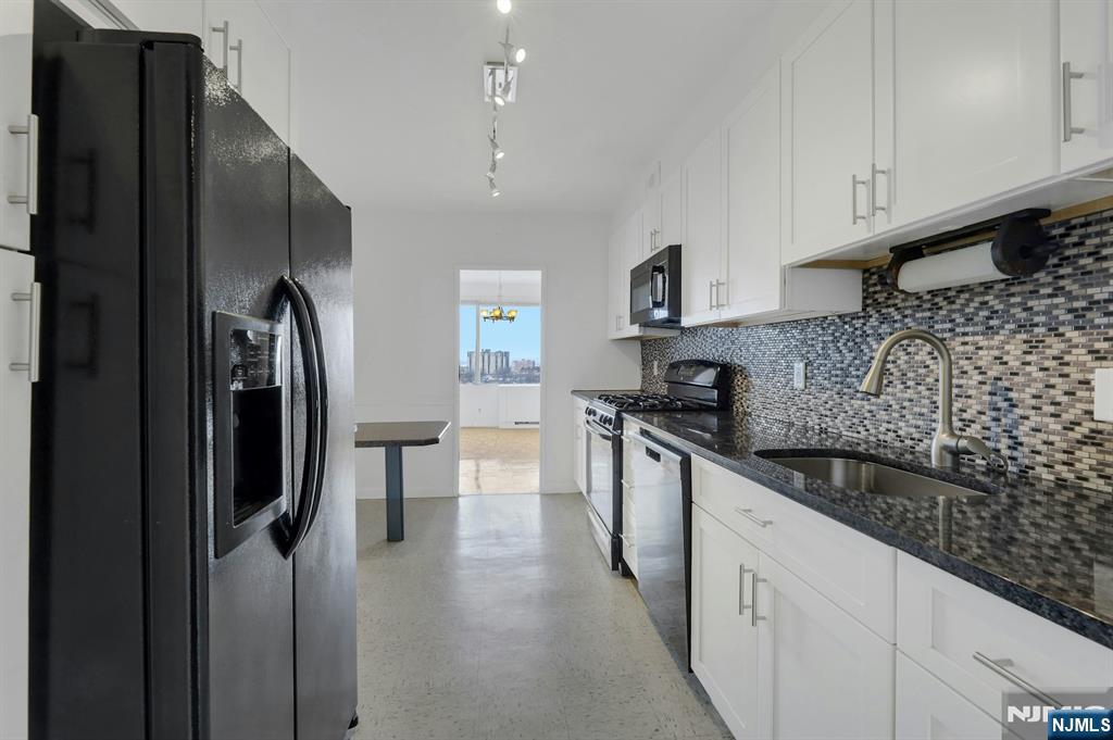 6 Horizon Road, Unit 1508 Fort Lee, NJ 07024 - Photo 22 of 46 a kitchen with stainless steel appliances granite countertop a refrigerator and a stove