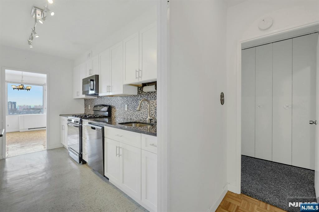 6 Horizon Road, Unit 1508 Fort Lee, NJ 07024 - Photo 24 of 46 a kitchen with white cabinets and stainless steel appliances