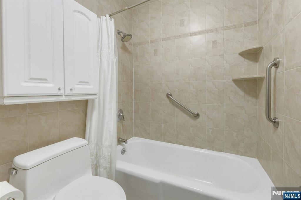 6 Horizon Road, Unit 1508 Fort Lee, NJ 07024 - Photo 35 of 46 a white bath tub sitting next to a white toilet