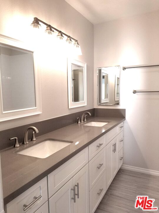 4866 1/2 McConnell Avenue Los Angeles, CA 90066 - Photo 6 of 11 a bathroom with a granite countertop sink and a mirror