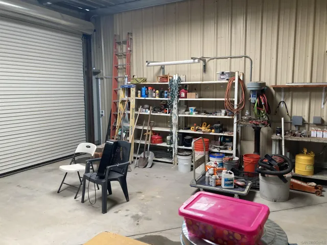 a en suite bathroom with a granite countertop sink and a mirror