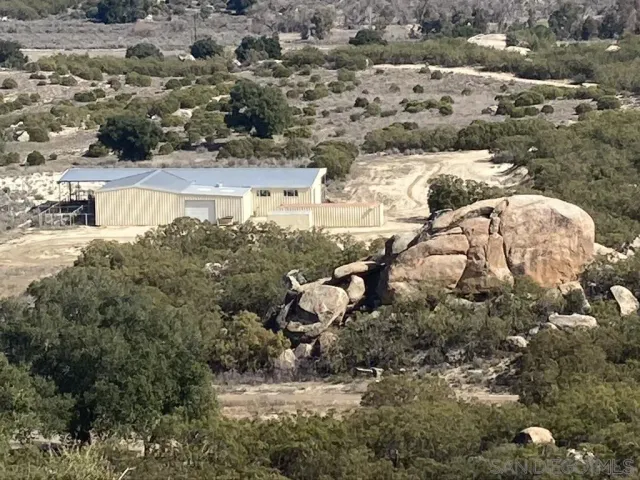 a view of a house with a wooden fence