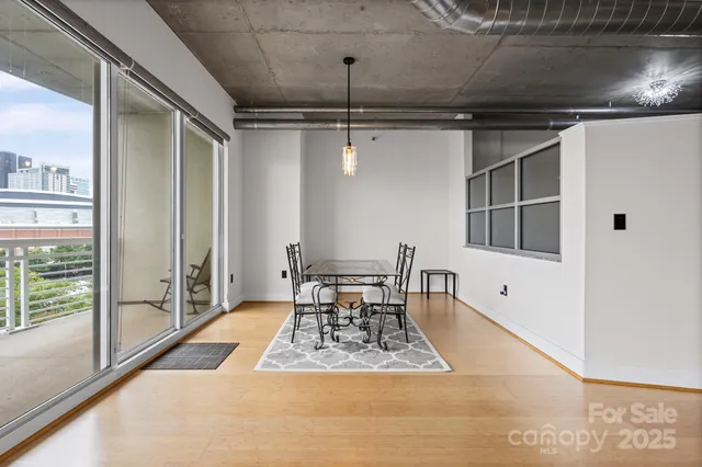 a view of a dining room with a table and chairs