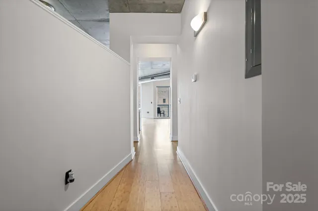 a view of a hallway with wooden floor