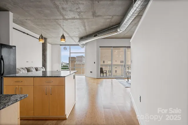 a view of a kitchen with a sink and wooden floor