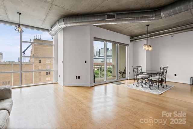 a view of a livingroom with furniture and floor to ceiling window