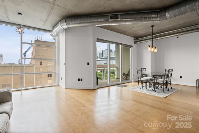 a view of a livingroom with furniture and floor to ceiling window