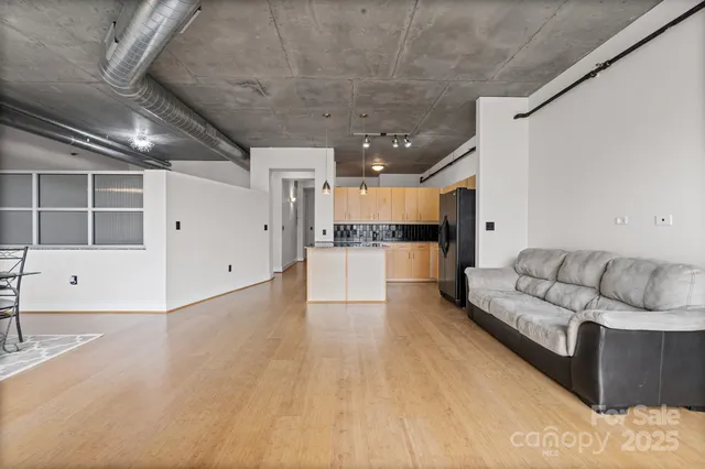 a living room with furniture and kitchen view