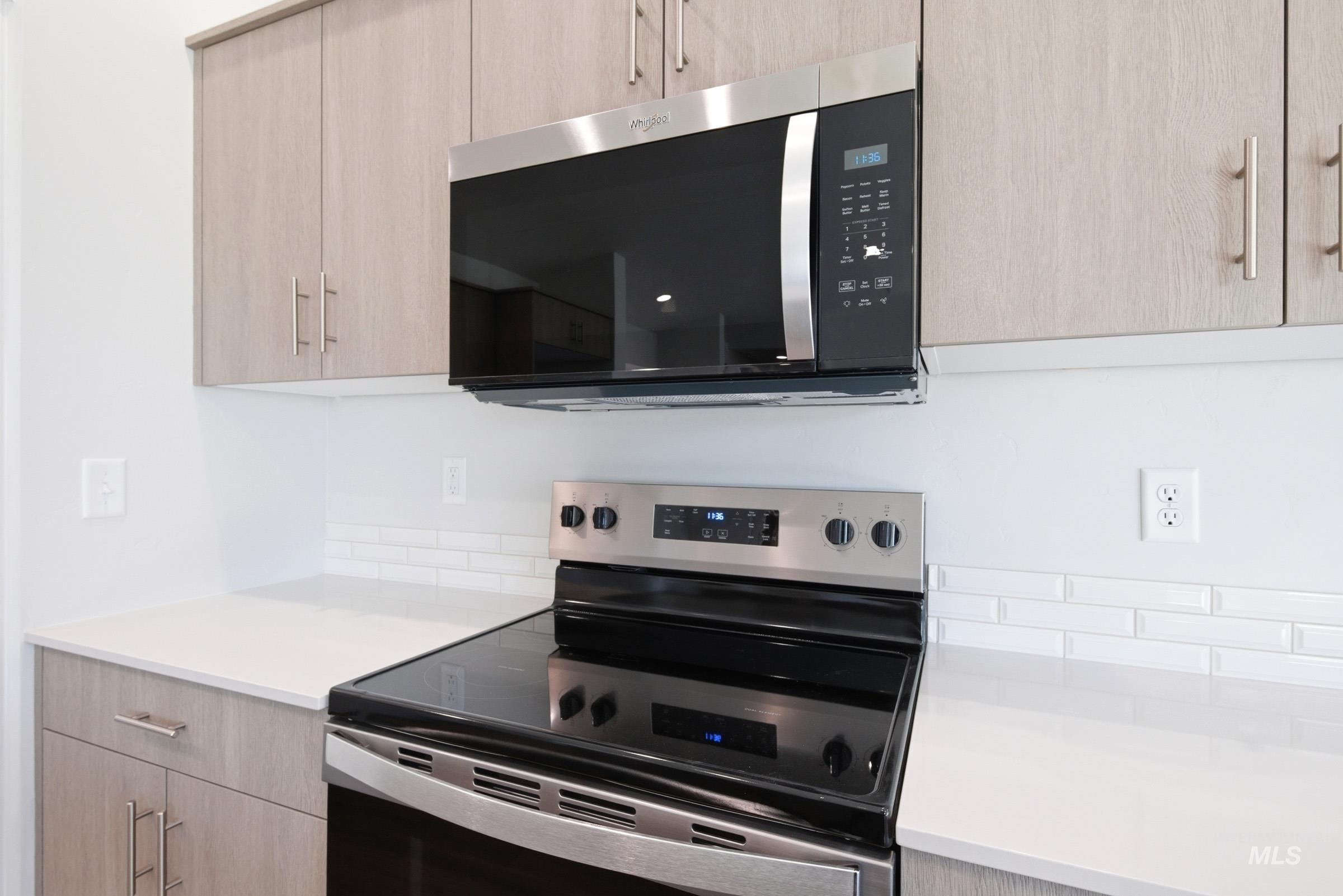 12877 Decatur Street Nampa, ID 83651 - Photo 5 of 22 Kitchen space featuring stainless steel appliances, light wood-finish cabinetry, white countertops, and a subway tile backsplash