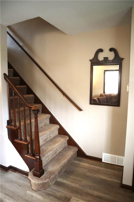 3059 Mt Troy Road Pittsburgh, PA 15212 - Photo 18 of 28 Staircase leads to private second-floor living spaces, creating a natural separation from main living areas.