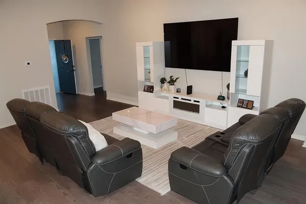 a living room with furniture and a flat screen tv