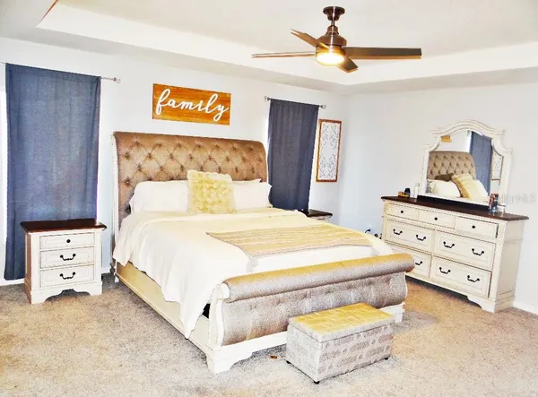 a bedroom with a bed and a chandelier