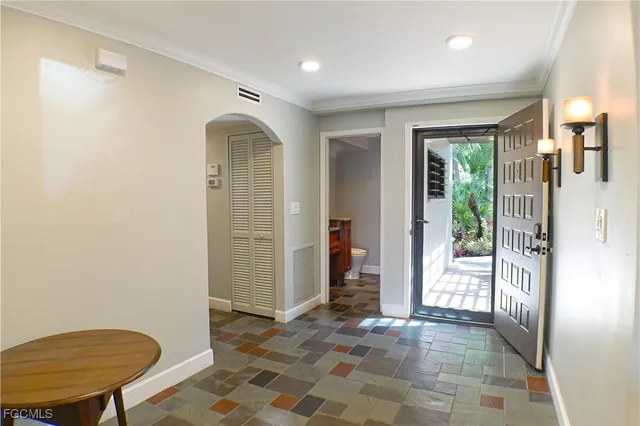 a view of a hallway with bathroom and glass door