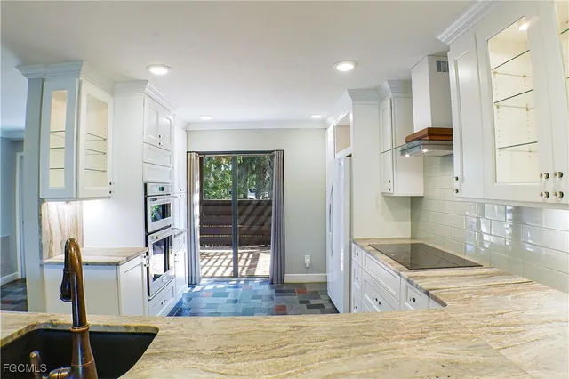 a open kitchen with stainless steel appliances kitchen island granite countertop a refrigerator and cabinets