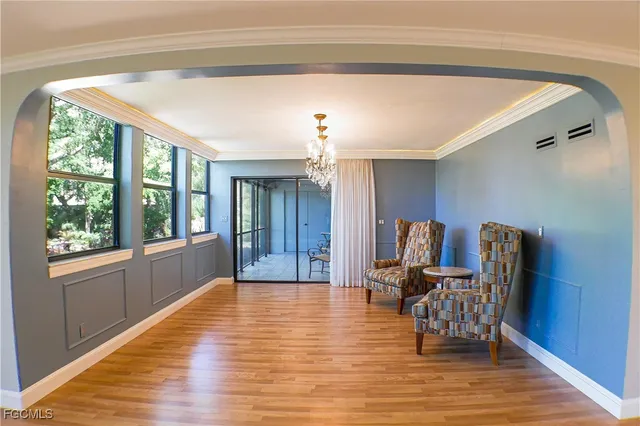 a view of a livingroom with furniture window and wooden floor