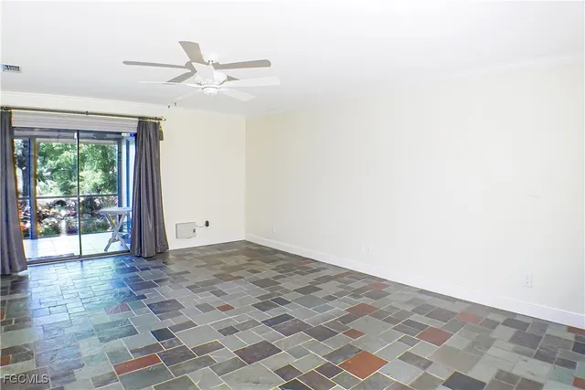 a view of a livingroom with a ceiling fan and window