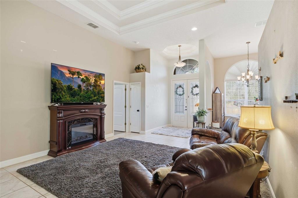 5580 South Kline Terrace Inverness, FL 34452 - Photo 13 of 55 a living room with furniture a flat screen tv and a fireplace