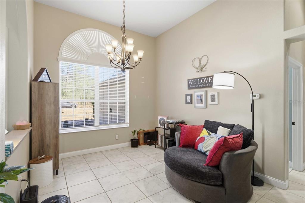 5580 South Kline Terrace Inverness, FL 34452 - Photo 14 of 55 a living room with furniture and a chandelier