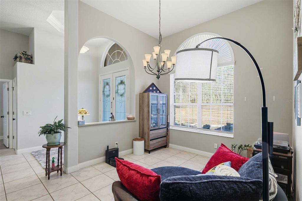 5580 South Kline Terrace Inverness, FL 34452 - Photo 5 of 55 a living room with furniture flowers and a chandelier