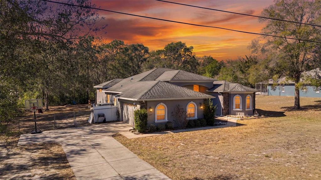 5580 South Kline Terrace Inverness, FL 34452 - Photo 53 of 55 a front view of a house with a yard and trees