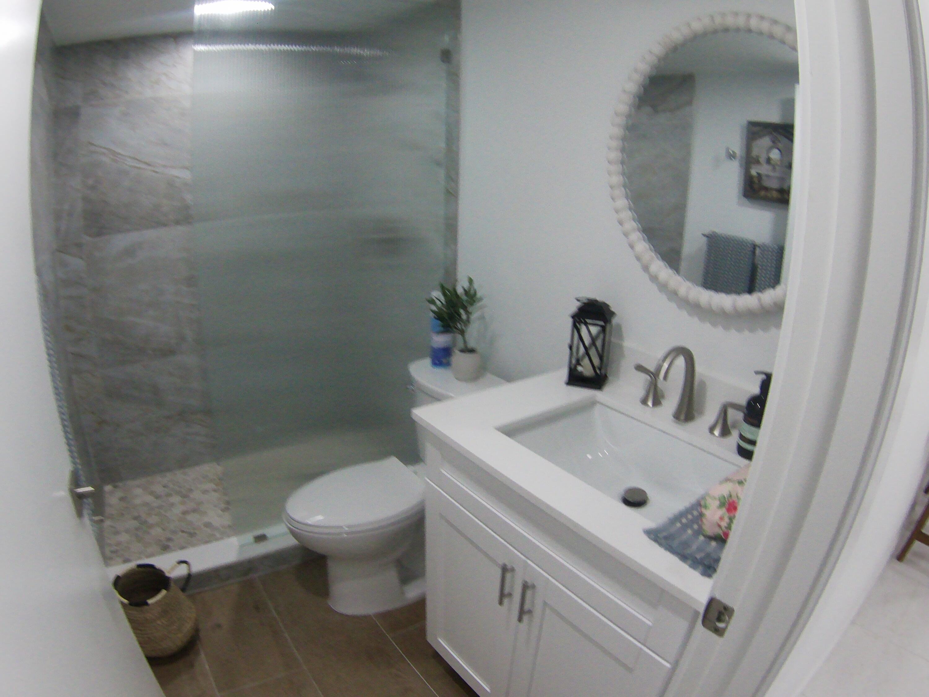 541 Normandy Lane Delray Beach, FL 33484 - Photo 11 of 23 a bathroom with a sink toilet and a mirror