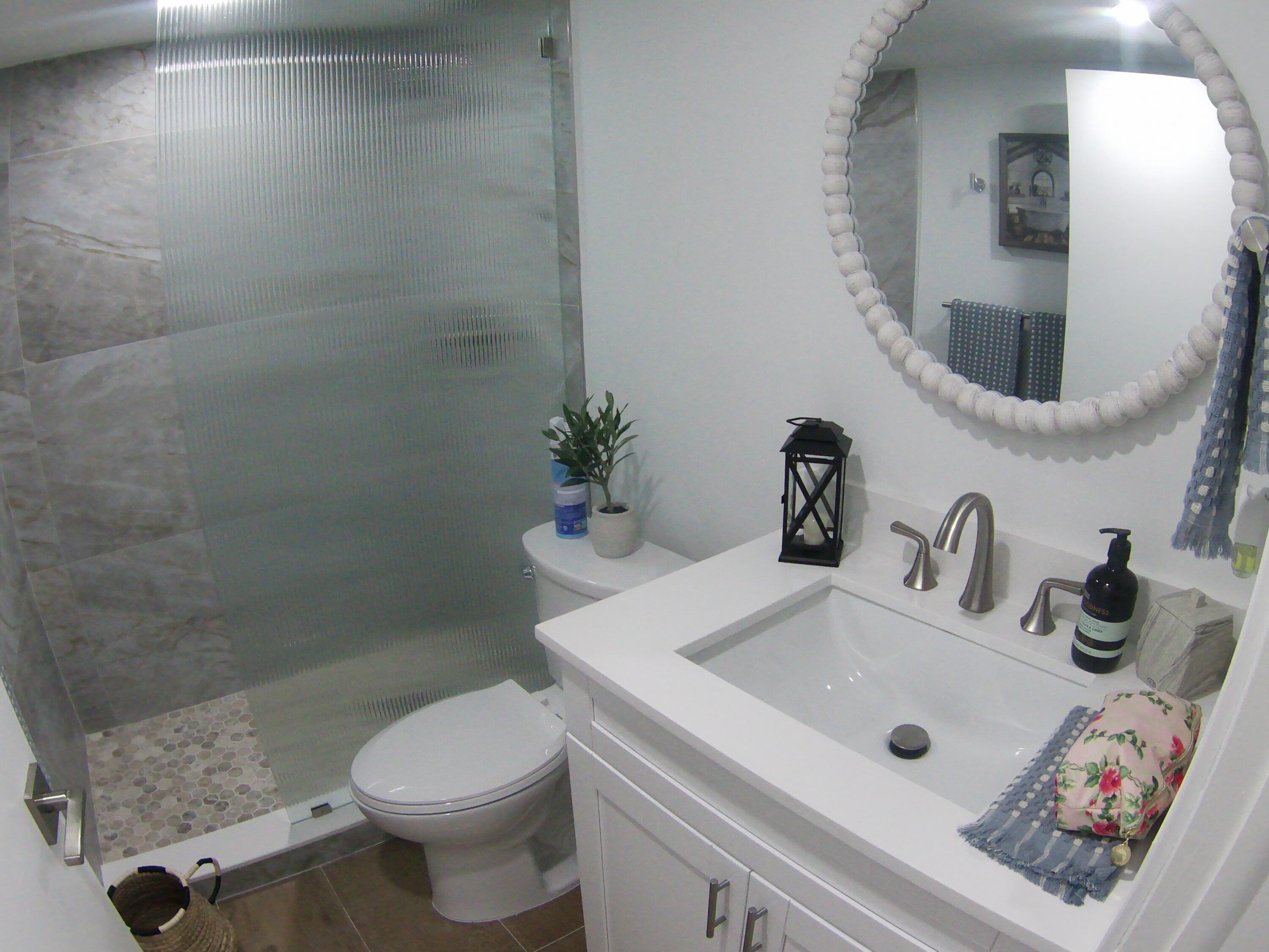 541 Normandy Lane Delray Beach, FL 33484 - Photo 12 of 23 a bathroom with a sink a toilet and shower
