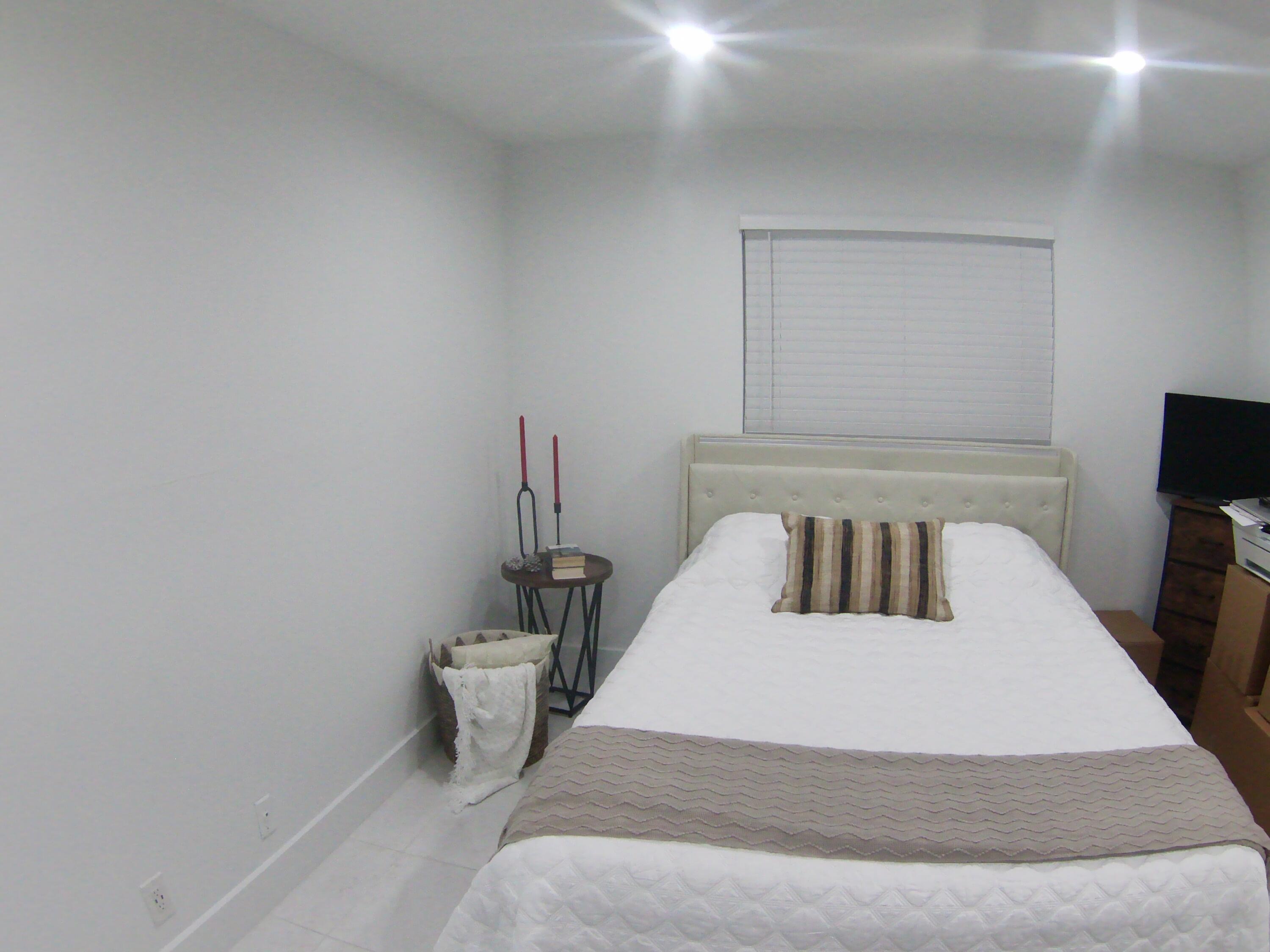 541 Normandy Lane Delray Beach, FL 33484 - Photo 14 of 23 a bedroom with a bed and a tv