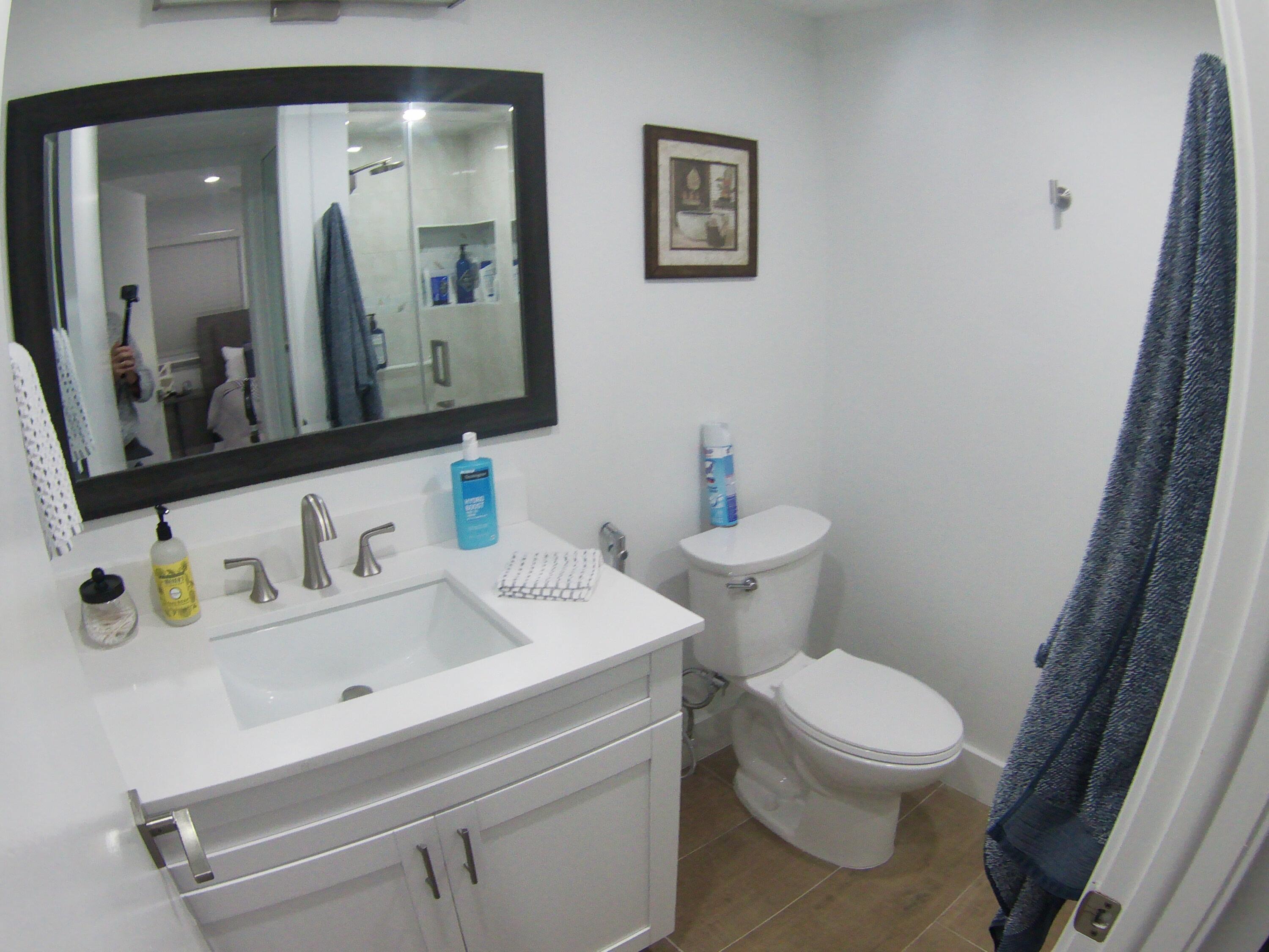 541 Normandy Lane Delray Beach, FL 33484 - Photo 20 of 23 a bathroom with a sink mirror and toilet