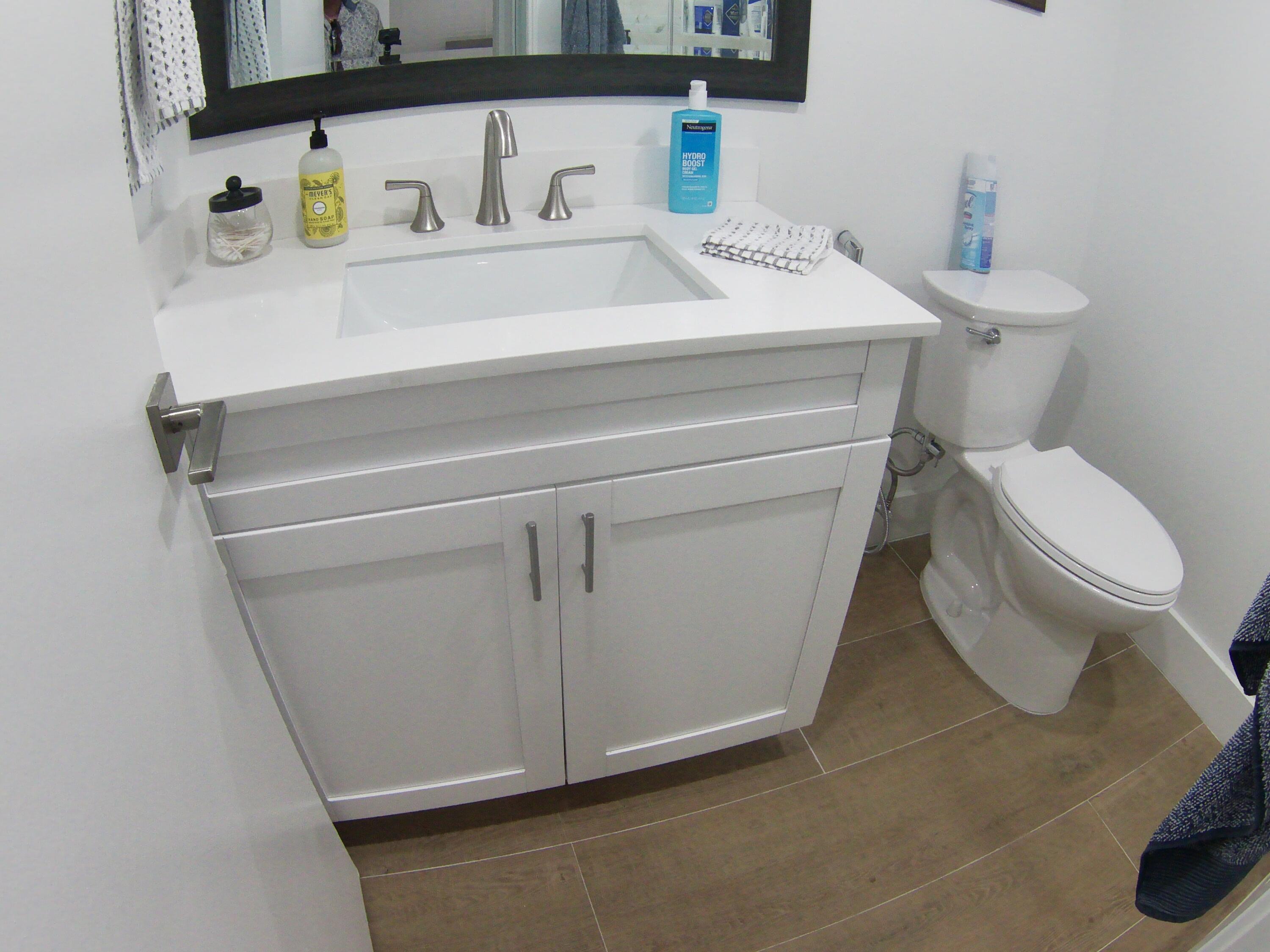 541 Normandy Lane Delray Beach, FL 33484 - Photo 23 of 23 a close view of a sink and a toilet in a bathroom