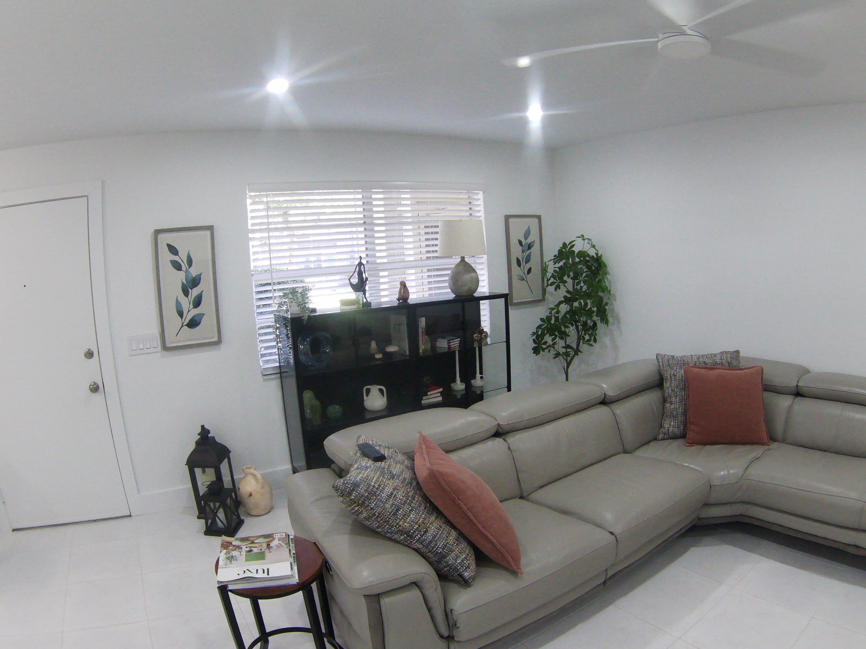 541 Normandy Lane Delray Beach, FL 33484 - Photo 6 of 23 a living room with furniture and a large window