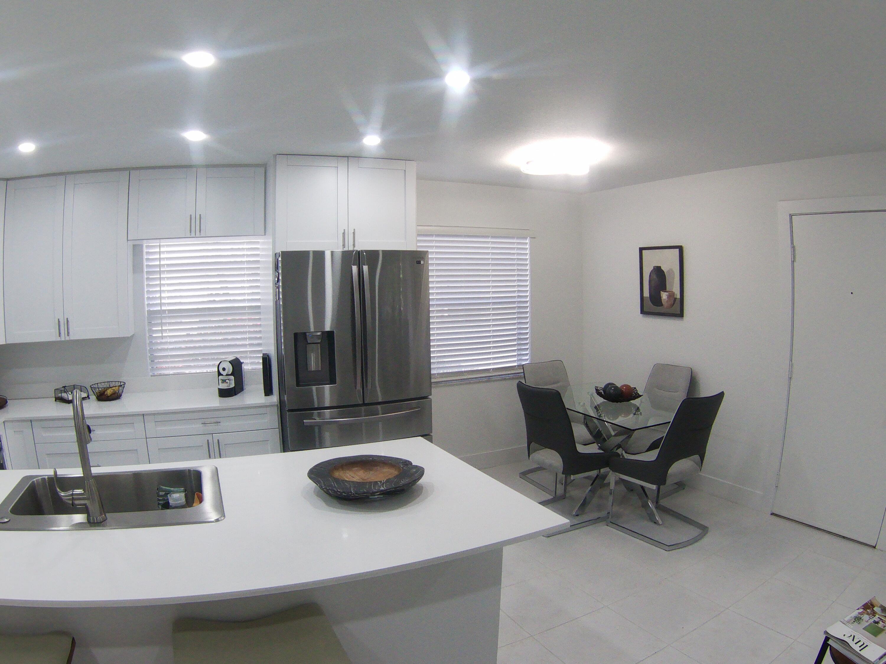 541 Normandy Lane Delray Beach, FL 33484 - Photo 8 of 23 a kitchen with a refrigerator and a sink