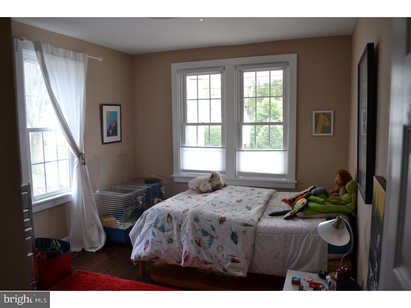 414 Righters Mill Road Gladwyne, PA 19035 - Photo 14 of 17 a bedroom with a bed a dresser next to a window
