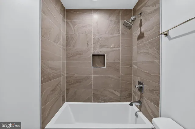 a bathroom with a shower and a toilet