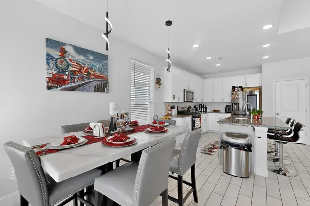 a kitchen with a dining table and chairs