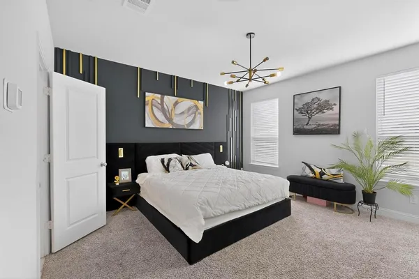 a bedroom with a bed and a chandelier